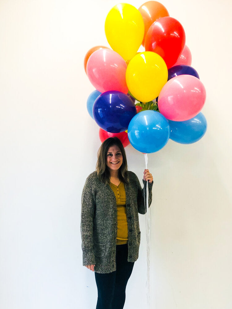 Happy child holds pink balloon.