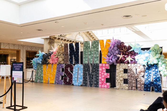 Multicoloured balloon archway with starburst balloon accents