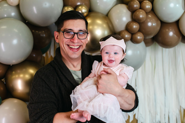 dad and baby girl looking at camera