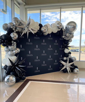 Capital Lincoln Regina grand opening background with Trademark Garland in black, white, and silver with starbursts