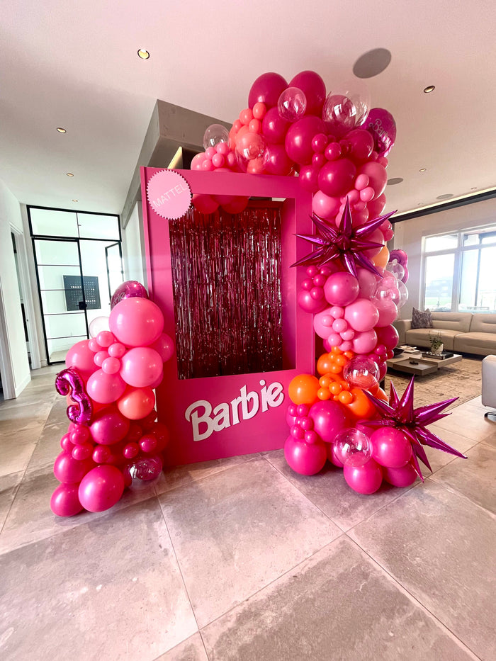 pink barbie box with shades of pink balloons