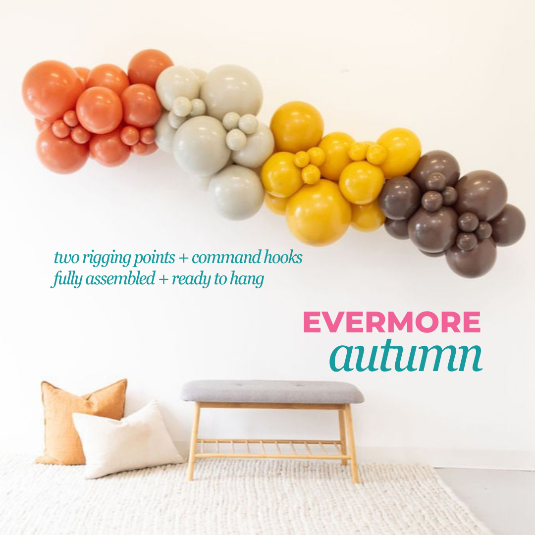 Colorful balloon arch with 'Evermore Autumn' text in a room setting.